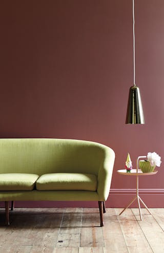 Pink living room with green sofa